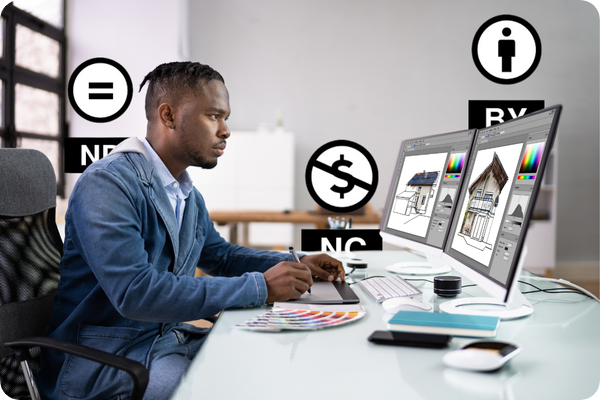 A graphic designer working on a PC, with different types of Creative Commons licences available at TikBox.io